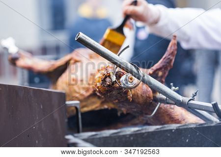 The Carcass Of A Lamb Is Roasted On A Spit. Close-up Carcass Of A Sheep That Is Roasting On The Spit