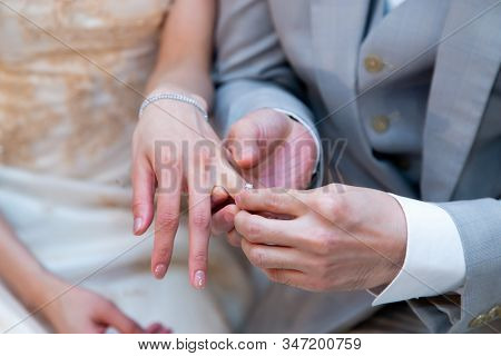 Happy Moment Of Exchanging (giving And Receiving) Diamond Engagement Rings During Traditional Marria
