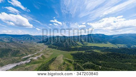 Aerial Panoramic Wide Banner View Of A Chike-taman Pass In The Altai Mountains With Green Trees, Blu