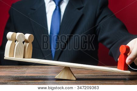 A Businessman Outweighs A Specialist Headman Over A Group Of People. Professional Efficiency, Busine