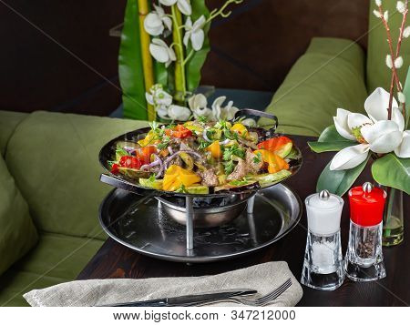 Saj, A Pan With Pieces Of Beef And Vegetables On The Table, Heated On Coals. Bright Colors, A Delici