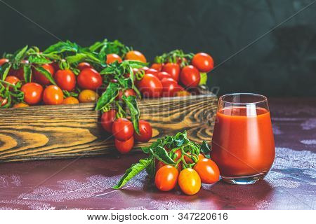 Glass Of Fresh Delicious Jummy Red Tomato Juice And Fresh Tomatoes In Wooden Box. Dark Background. C