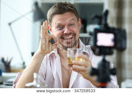 Drunk Male Director Holds A Glass With Whiskey In Hand And Greets His Subservient Portrait. Work Of 