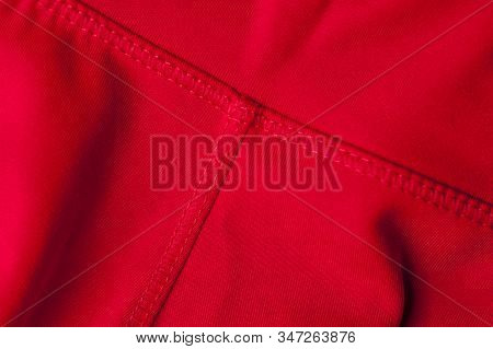 Close-up Fragment Of Crumpled Red Polyester Fabric. Concept Of High-quality Raw Materials For Clothi
