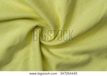 Close-up Fragment Of Crumpled Beautiful Yellow Cotton Fabric. Concept Of High-quality Raw Materials 