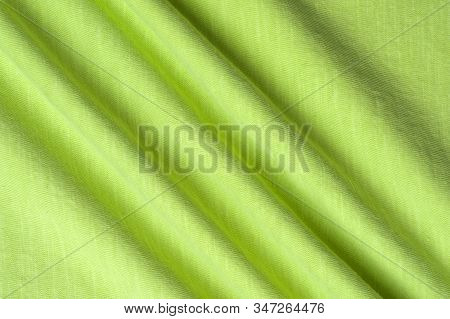 Close-up Fragment Of A Beautiful Yellow Cotton Fabric. Concept Of High-quality Raw Materials For Tai