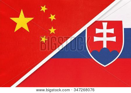 China Or Prc Vs Slovakia National Flag From Textile. Relationship Between Asian And European Countri