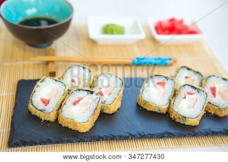 Maki Roll With Salmon, Popular Japanese Cuisine. Sushi Roll With Fish, Cream Cheese And Vegetables