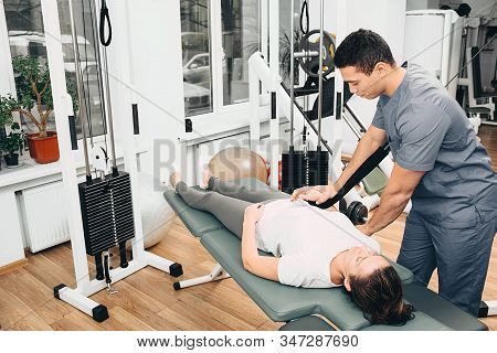 Kinesitherapy, Exercises. Kinesiologist Trains With The Patient, Treating Joint Pain