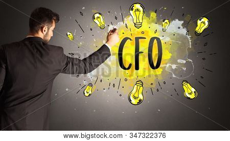 businessman drawing colorful light bulb with CFO abbreviation, new technology idea concept