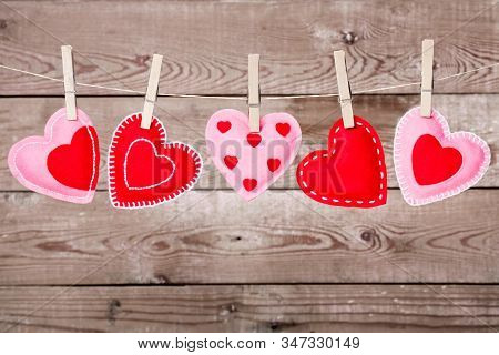 A Clothesline With Cute Valentines Day Hearts Decorations On A Rustic Background Best