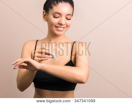 Protect And Moisturize Your Skin. Closeup View Of Simpatico Woman With Clean Skin Applying Body Oil 