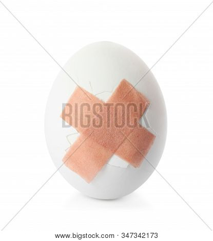 Cracked Egg With Sticking Plasters Isolated On White