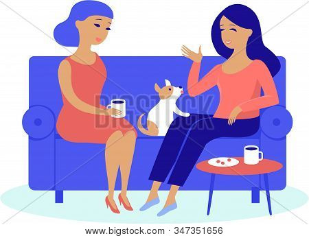 Young Women Friends Having Cosy Conversation Drinking Coffee Or Tea At Home