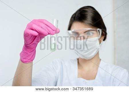 Research Conducted By A Laboratory Assistant Holding A Test Tube Of The Agro-laboratory