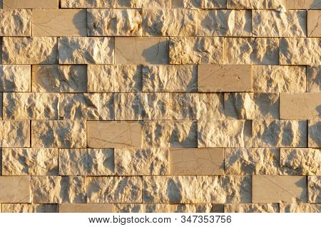 Textured Marble Tiles Illuminated By The Setting Sun. Beige Marble Wall Texture Wallpaper Background