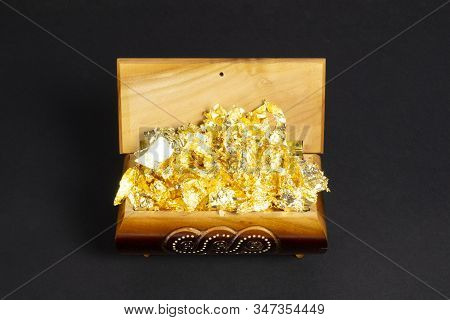Opened Single Casket With Golden Foil As Gold Inside On The Dark Paper Background, Wooden Box, Woode