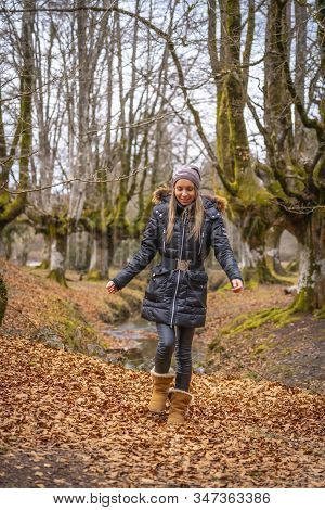 A Young Woman On The Path In The Otzarreta Forest In The Gorbea Natural Park, Bizkaia. Basque Countr