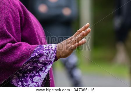 Closeup Midsection Of Female Wearing Full Sleeve Purple Dress While Gesturing Telling Story During F
