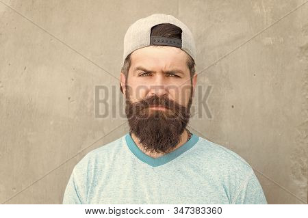 Bearded And Moustached. Bearded Man On Grey Wall. Serious Bearded Hipster In Casual Summer Style. Ca