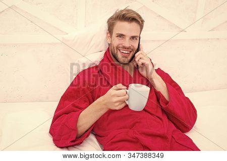 Hipster Guy Pajamas Bathrobe Freelance Worker Relaxing At Home. Remote Work Concept. Glad To Hear. M