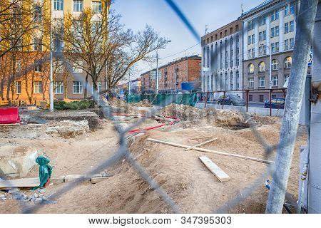 Underground Rennovation Works In City With Protective Fence Wire At Foregound. Horizontal Image