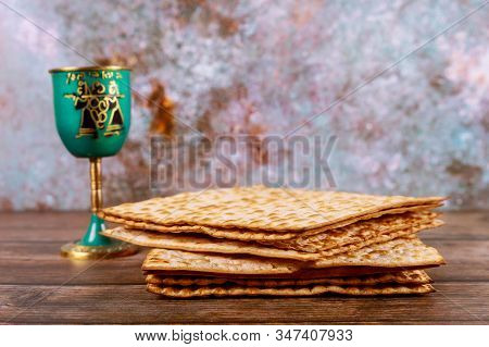 Jewish Holiday Table For Passover With Matzah And Metalic Cup Of Kosher Wine