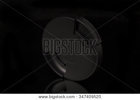 Lens Cap Isolated On Black Background. Close Up