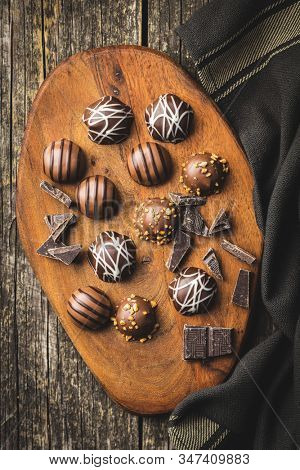 Praline bonbons. Chocolate truffles on curring board. Top view.