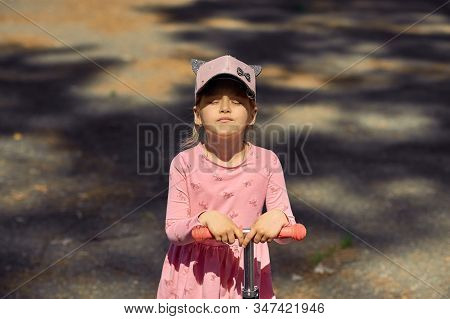 The Little Girl In The Cap Turned Her Face To The Sun And Closed Her Eyes To Catch The Warm Summer S