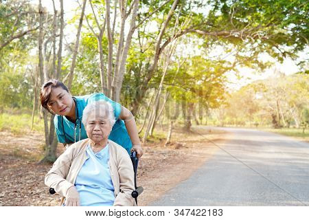 Doctor Help And Care Asian Senior Or Elderly Old Lady Woman Patient Sitting On Wheelchair At Park In