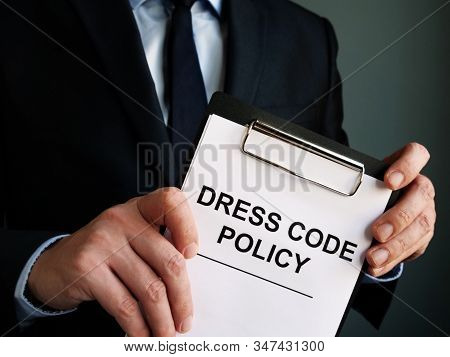 Manager Is Holding Dress Code Policy Papers.