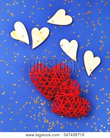 Beautiful Red And Wooden Hearts On The Cornflowerblue Background In The Golden Star Sequins. St Vale