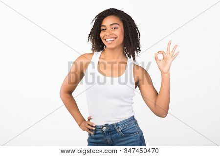 Im Fine. Smiling Curly Black Woman Showing Ok Sign And Looking At The Camera Over White Background, 