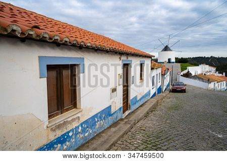 Odeceixe, Portugal - January 22, 2020: Cobblestone Street With Blue And White Traditional Colorful H