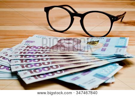 Ukrainian Hryvnia, New Banknotes 1000 Hryvnia. Hryvnia Uah . Close-up Shot On A Wooden Background. F