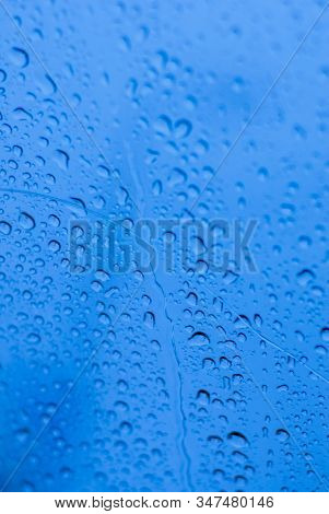 Water Drops On Glass Window With Blue Background