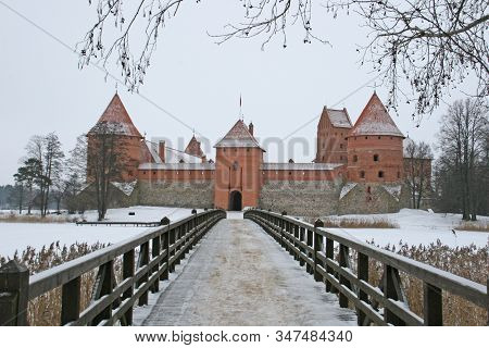 Gothic Red Brick Trakai Castle In Winter Time, In The Middle Of Frozen Lake, Lithuania