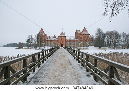 Gothic Red Brick Trakai Castle In Winter Time, In The Middle Of Frozen Lake, Lithuania