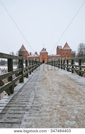 Gothic Red Brick Trakai Castle In Winter Time, In The Middle Of Frozen Lake, Lithuania