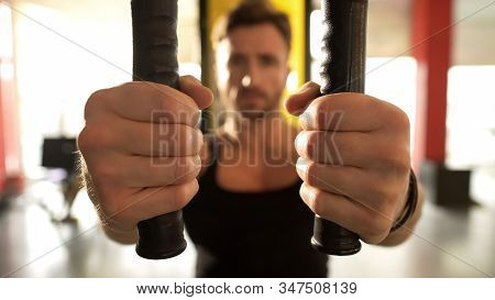 Male With Highly Developed Muscles Doing Chest Fly Workout Gym, Hands Close-up