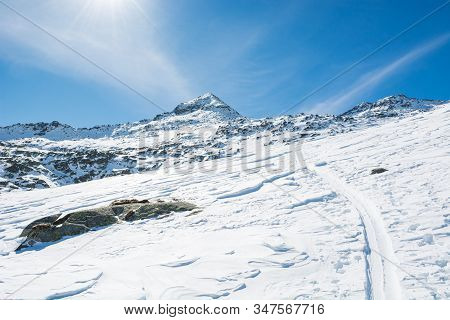 Spectacular Winter Mountain View With Ski Trail Ascending A Slope.
