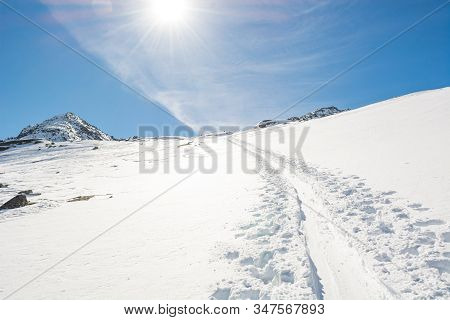 Spectacular Winter Mountain View With Ski Trail Ascending A Slope.