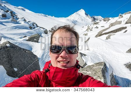 Male Mountaineering Taking A Selfie High In The Mountains.