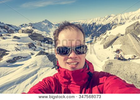 Male Mountaineering Taking A Selfie High In The Mountains.