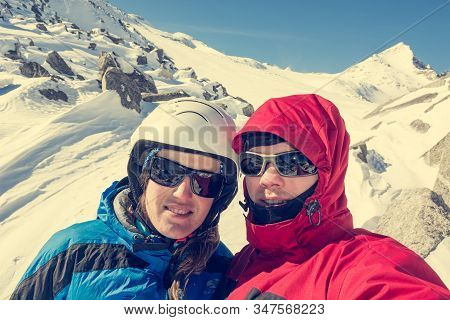 Happy Couple Posing On A Skiing Trip To The Mountains.