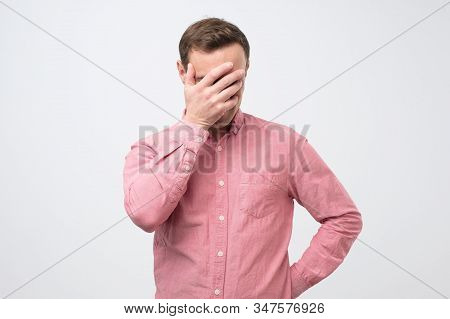 Shy Embarrassed Young Man Making Faceplam Gesture.