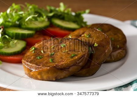 Seitan With Vegetables On Wooden Table Close Up. Fake Meat