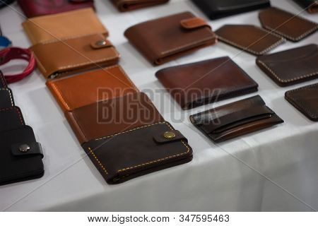 Set Of Hand Made Leather Man Wallet. Leather Craft. On Table Background