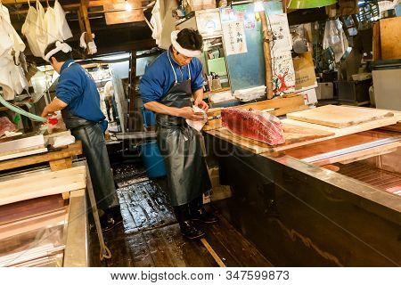 Tokyo, Japan - January 15, 2010: Early Morning At Fish Market. Two Vendors Cutting Tuna At Tsukiji F
